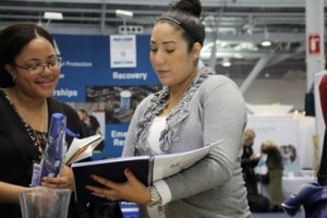 Healthy Futures Health Educator talking with APHA meeting attendee